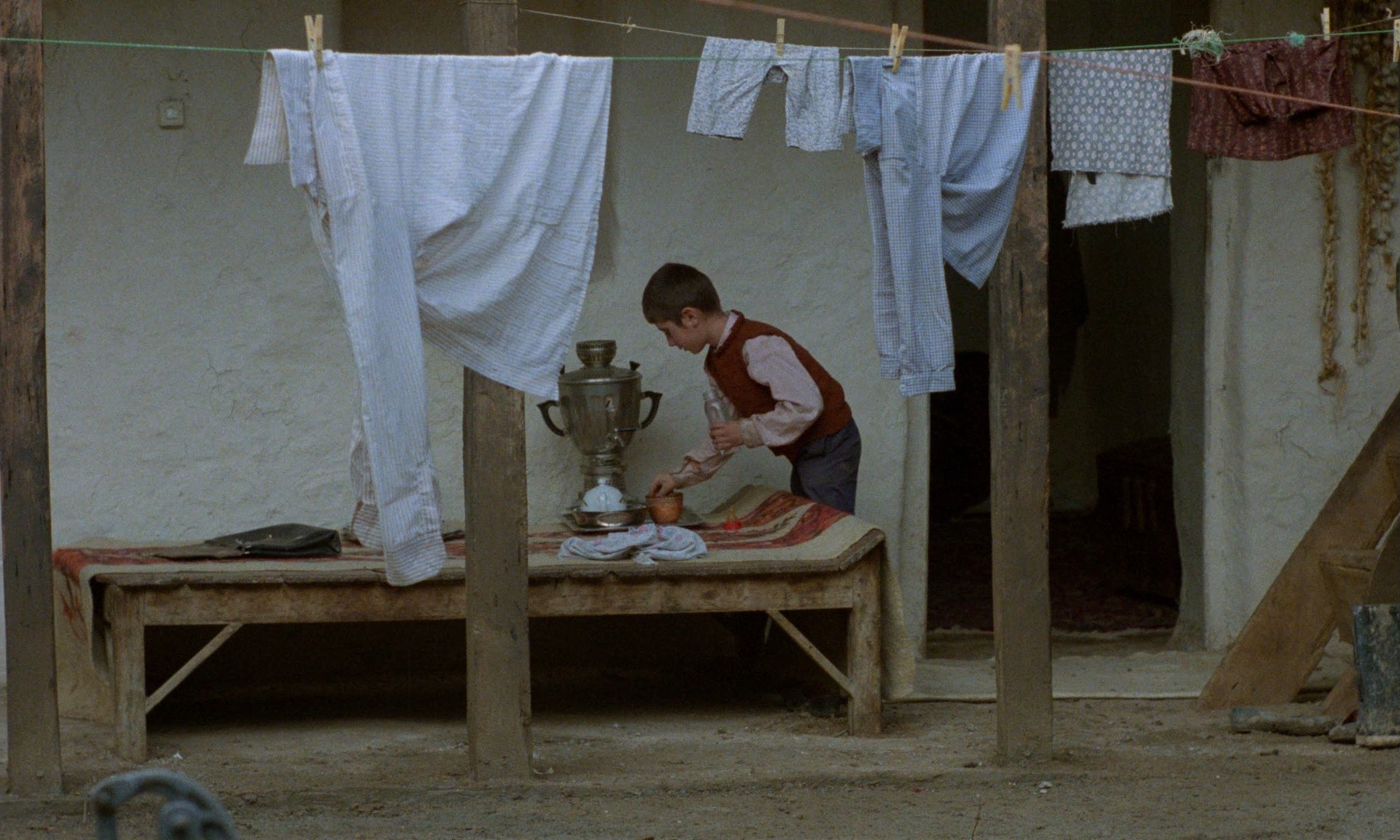 still from Where Is the Friend's House? (1987) by Abbas Kiarostami — a child framed in medium-wide, character and surroundings held together